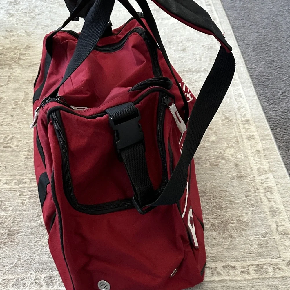 Ben Sherman Burgundy Duffel Bag with Black Accents.